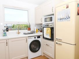 A kitchen with appliances and a sink at Elberry Cove View in Paignton
