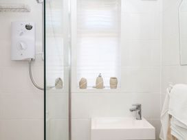 A bathroom with a shower and sink at Elberry Cove View in Paignton