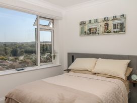 A bedroom with a bed and window view at Elberry Cove View in Paignton
