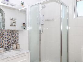 A bathroom with a shower and sink at Elberry Cove View in Paignton