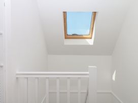 A staircase with a skylight at Elberry Cove View in Paignton