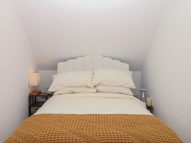 A bedroom with a bed and bedside lamp at Elberry Cove View in Paignton