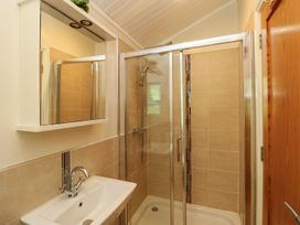 A bathroom with a shower and sink at Fir Tree Lodge, Coniston 3, White Cross Bay near Windermere