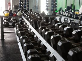A gym with dumbbells and kettlebells at Fir Tree Lodge in Coniston 3, White Cross Bay near Windermere