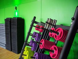 A gym with dumbbell weights and exercise mats at Fir Tree Lodge, Coniston 3, White Cross Bay near Windermere