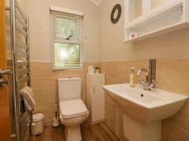 A bathroom featuring a sink and toilet at Fir Tree Lodge, White Cross bay on Windermere, Troutbeck Bridge