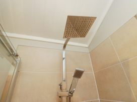 A showerhead and handheld shower in a bathroom at Fir Tree Lodge White Cross bay on Windermere Troutbeck Bridge