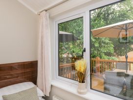 A bedroom with a window view at Fir Tree Lodge White Cross bay on Windermere Troutbeck Bridge