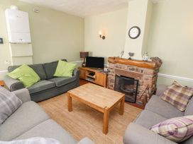 A living room with sofas and a coffee table at Mellfell Cottage near Watermillock