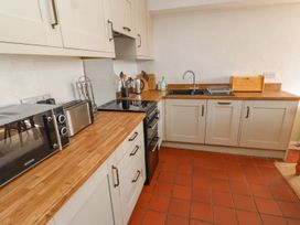 A kitchen with appliances and a sink at Mellfell Cottage near Watermillock