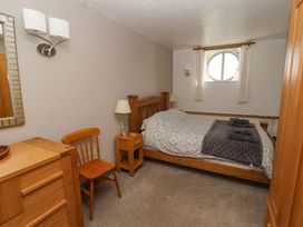 A bedroom with a bed and nightstand at Mellfell Cottage near Watermillock