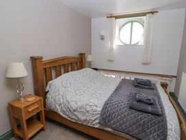 A bedroom with a double bed and bedside table at Mellfell Cottage near Watermillock
