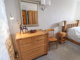 A bedroom with a chest of drawers and a bed at Mellfell Cottage near Watermillock