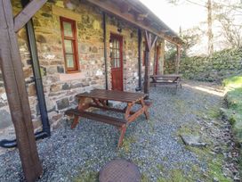 An outdoor area with tables and benches at Mellfell Cottage near Watermillock