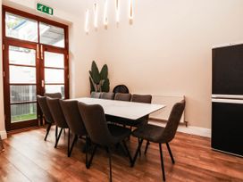 A dining room with a table and chairs at Tudno Lodge in Llandudno