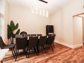 A dining room with a table and chairs at Tudno Lodge in Llandudno