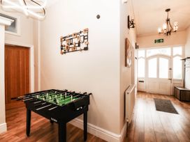 A hallway with a foosball table and a door at Tudno Lodge in Llandudno