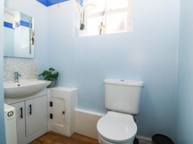 A bathroom with a sink and toilet at Tudno Lodge in Llandudno
