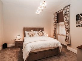 A bedroom with a bed and bedside table at Tudno Lodge in Llandudno