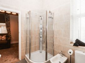 A bathroom with a shower, toilet, and bidet at Tudno Lodge Llandudno
