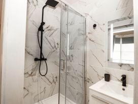 A bathroom with a shower and sink at Tudno Lodge in Llandudno