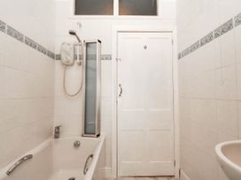 A bathroom with a bathtub and shower at Tudno Lodge in Llandudno