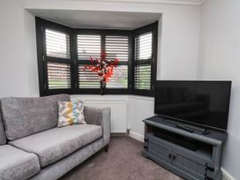 A living room with a sofa and television at 64 Derwent Road in Whitby