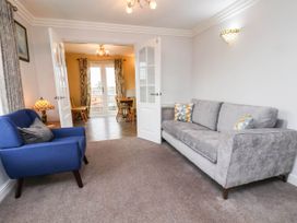 A living room with a sofa and armchair at 64 Derwent Road, Whitby