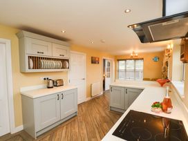 A kitchen with cabinets and countertop at 64 Derwent Road in Whitby