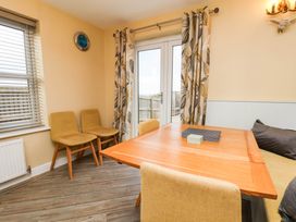 A dining room with a table and chairs at 64 Derwent Road in Whitby