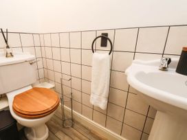 A bathroom with a toilet and sink at 64 Derwent Road in Whitby