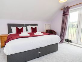 A bedroom with a bed and a nightstand at 64 Derwent Road in Whitby