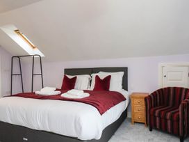 A bedroom with a bed and chair at 64 Derwent Road in Whitby