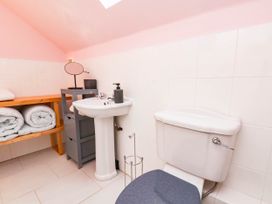 A bathroom with a toilet and sink at 64 Derwent Road in Whitby