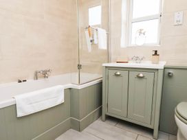 A bathroom with a bathtub and sink at 64 Derwent Road in Whitby