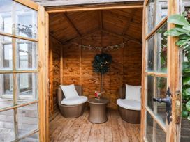 A garden room with seating and a table at 64 Derwent Road, Whitby