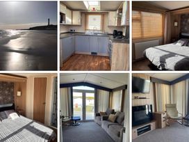 A beach view, kitchen with appliances and living area with sofa at Silversands Holiday Park, Indi’s Retreat at Silversands Helston