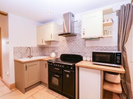 A kitchen with oven and microwave at The burrow at Aveling Cottage in Lydney