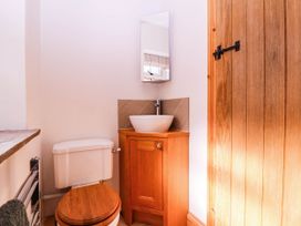 A bathroom with a toilet and sink in The burrow at Aveling Cottage Lydney
