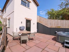 An outdoor area with a table and chairs at The Burrow at Aveling Cottage in Lydney