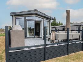 An outdoor area with a deck and furniture at Lakewood Plot 7 in Clacton-on-Sea