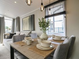 A dining area with a table and chairs at Lakewood Plot 7 Clacton-on-Sea