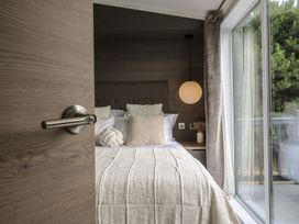 A bedroom with a bed and bedside table at Lakewood Plot 7 Clacton-on-Sea