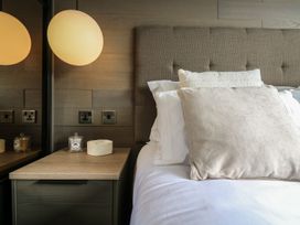 A bedroom with a bed and bedside table at Lakewood Plot 7, Clacton-on-Sea