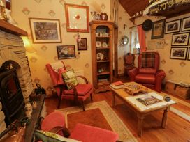 A living room with chairs and a table at Teresa's Cottage