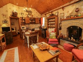 A kitchen with dining table and chairs at Teresa's Cottage