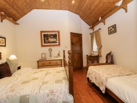 A bedroom with two beds and a nightstand at Teresa's Cottage
