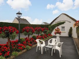 A garden with flowers and seating at Teresa's Cottage