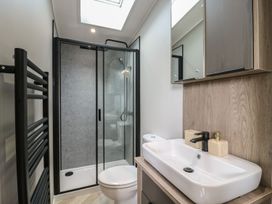 A bathroom with a shower, toilet, and sink at Lakewood Plot 9 in Clacton-on-Sea