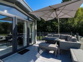 An outdoor seating area with a sofa and table at Lakewood Plot 9 St. Osyth